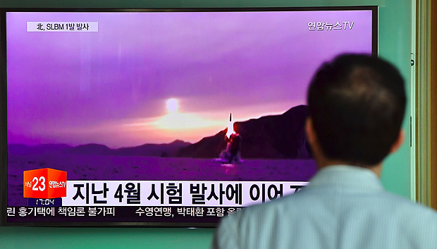 A man watches a television news broadcast at a railway station in Seoul on July 9, 2016, showing file footage of a North Korean missile launch. North Korea on July 9 test-fired what appeared to be a submarine-launched ballistic missile (SLBM), Seoul's defence ministry said, a day after the US and South Korea decided to deploy an advanced missile defence system in the South. / AFP PHOTO / JUNG YEON-JE ORG XMIT: JYJ737