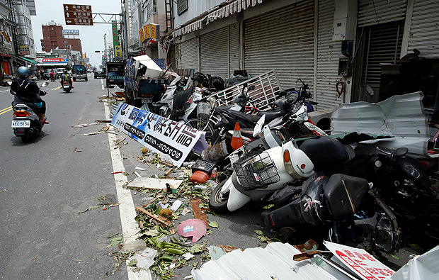 A motorcyclist rides past motorcycles damaged by Typhoon Nepartak in Taitung, Taiwan July 9, 2016. REUTERS/Tyrone Siu ORG XMIT: GGGTS09