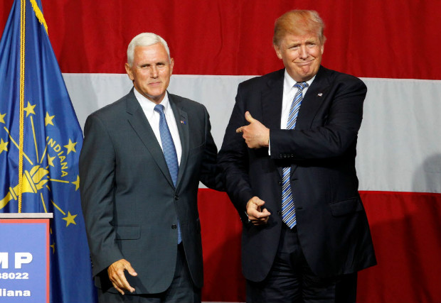 Republican presidential candidate Donald Trump (R) and Indiana Governor Mike Pence (L) wave to the crowd before addressing the crowd during a campaign stop at the Grand Park Events Center in Westfield, Indiana, July 12, 2016. REUTERS/John Sommers II ORG XMIT: IND132