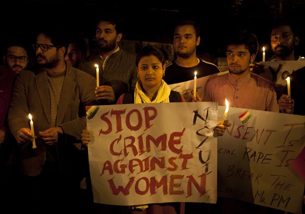Indian youth hold candles during a protest against sexual violence in New Delhi, India, Monday, Feb. 9, 2015.Police were searching Monday for a man who raped a Japanese student sightseeing in northern India, while elsewhere they announced the arrest of eight men suspected of brutally raping and killing a Nepalese woman, as India authorities continue to struggle to address chronic sexual violence. (AP Photo/ Tsering Topgyal) ORG XMIT: DEL132