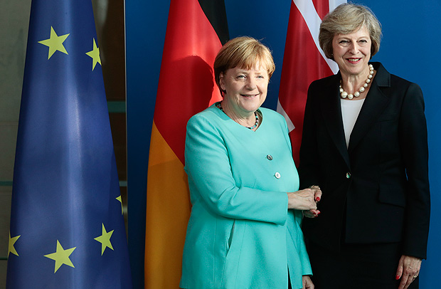 German Chancellor Angela Merkel, left, and British Prime Minister Theresa May shake hands after a news conference during a meeting at the chancellery in Berlin Wednesday, July 20, 2016, on May's first foreign trip after being named British Prime Minister. (AP Photo/Markus Schreiber) ORG XMIT: MSC129