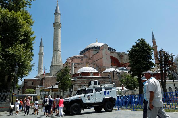 Tourists enter the Byzantine-era monument of Hagia Sophia as they pass by an armoured police vehicle in the Old City of Istanbul, Turkey, July 13, 2016. Picture taken July 13, 2016. REUTERS/Murad Sezer ORG XMIT: GGGIST02