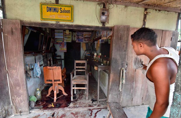 A villager looks at the blood stains on the floor of a shop after a militant attack on a market at Balajan Tinali, in the Kokrajhar district of Assam, on August 6, 2016. The death toll from an attack in India's northeastern Assam state, where gunmen opened fire on a busy market, jumped to 15 on August 6, as three more people succumbed to their injuries. / AFP PHOTO / Biju BORO