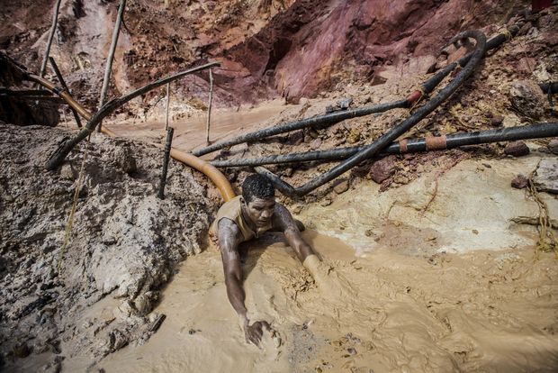 One of the watery pits of an illegal Cuatro Muertos mine outside Las Claritas, Venezuela, July 20, 2016. The cratered economy has sent many Venezuelans to work in the countrys illegal gold mines scattered across the jungle, where the primitive conditions have seen malaria return with a vengeance. (Meridith Kohut/The New York Times)
