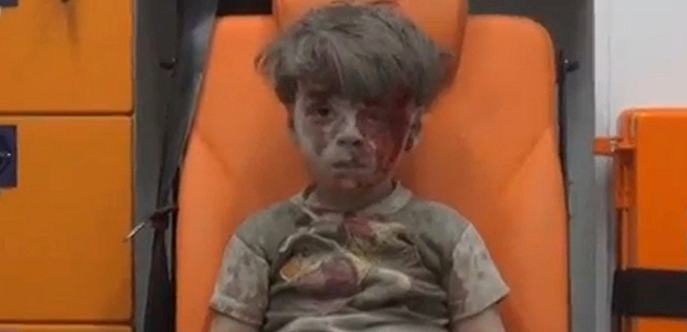 A still image taken on August 18, 2016 from a video posted on social media said to be shot in Aleppo on August 17, 2016, shows a boy with bloodied face sitting in an ambulance, after an airstrike, Syria. Social Media ATTENTION EDITORS - THIS IMAGE WAS PROVIDED BY A THIRD PARTY. EDITORIAL USE ONLY. NO RESALES. NO ARCHIVE. REUTERS IS UNABLE TO INDEPENDENTLY VERIFY THIS IMAGE. TPX IMAGES OF THE DAY ORG XMIT: SCR01