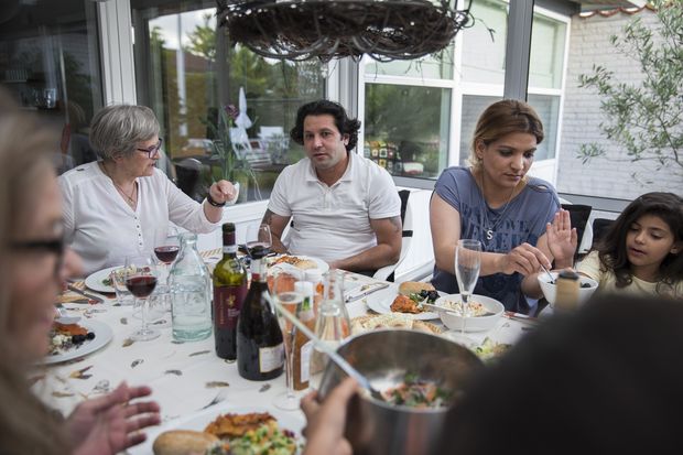 Housam Mohammed Shamden, a Syrian refugee, and his family, have dinner at the home of several members of the Kind Citizens group, who try to help immigrants settle, in Randers, Denmark, Aug. 6, 2016. The thousands of Muslim asylum seekers pouring into Denmark have spawned a backlash, and questions over whether the country has a latent racial hostility at its core. (Ilvy Njiokiktjien/The New York Times)