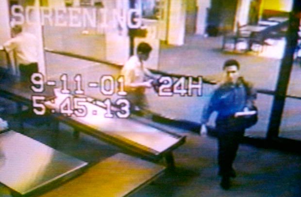 ORG XMIT: 065901_1.tif Two men identified by authorities as suspected hijackers Mohammed Atta (R) and Abdulaziz Alomari (C) pass through airport security September 11, 2001 at Portland International Jetport in Maine in an image from airport surveillance tape released September 19, 2001. Authorities say the two men took a commuter flight to boston before boarding American Airlines Flight 11, which was one of four jetliners hijacked on September 11 and one of two which were crashed into New York's World Trade Center. REUTERS/PORTLAND POLICE DEPARTMENT-Handout 