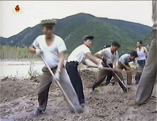 In this undated image from video distributed on Monday, Sept. 12, 2016, by North Korean broadcaster KRT, North Korean workers build levees along a river bank. North Korea is mobilizing to deal with a disastrous flood that killed more than 130 people, destroyed tens of thousands of homes and crippled infrastructure in its northern-most province. (KRT via AP) ORG XMIT: BKWS301