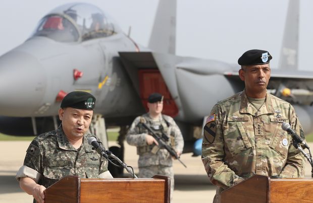 South Korean Chairman of the Joint Chiefs of Staff Gen. Lee Sun Jin, left, speaks to the media as U.S. Gen. Vincent Brooks, commander of the United Nations Command, US Forces Korea and Combined Forces Command, listens after U.S. B-1 bomber flying over Osan Air Base in Pyeongtaek, South Korea, Tuesday, Sept. 13, 2016. The United States on Tuesday sent nuclear-capable supersonic bombers streaking over ally South Korea in a show of force meant to cow North Korea after its recent nuclear test and also to settle rattled nerves in the South. (AP Photo/Lee Jin-man) ORG XMIT: LJM107