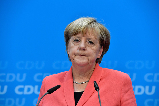 German chancellor Angela Merkel of the Christian Democratic Union (CDU) speaks during a press conference one day after regional election polls in Berlin on September 19, 2016. The Christian Democratic Union (CDU) party was reeling after another stinging poll loss, as an upstart populist party poached votes in a Berlin state election by railing against her liberal refugee policy. / AFP PHOTO / John MACDOUGALL