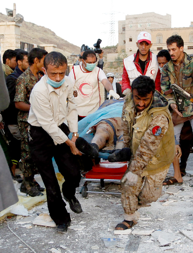 EDITORS NOTE: Graphic content / Yemeni rescue workers carry a victim on a stretcher amid the rubble of a destroyed building following reported airstrikes by Saudi-led coalition air-planes on the capital Sanaa on October 8, 2016. Rebels in control of Yemen's capital accused the Saudi-led coalition fighting them of killing or wounding dozens of people in air strikes on Sanaa. The insurgent-controlled news site sabanews.net said that coalition planes hit a building in the capital where people had gathered to mourn the death of an official, resulting in 