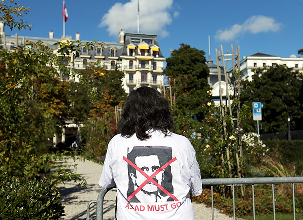 A woman stands outside the Beau-Rivage Palace ahead of Syria talks in Lausanne, Switzerland, October 15, 2016. The T-shirt reads: "Assad must go". REUTERS/Denis Balibouse ORG XMIT: DBA04