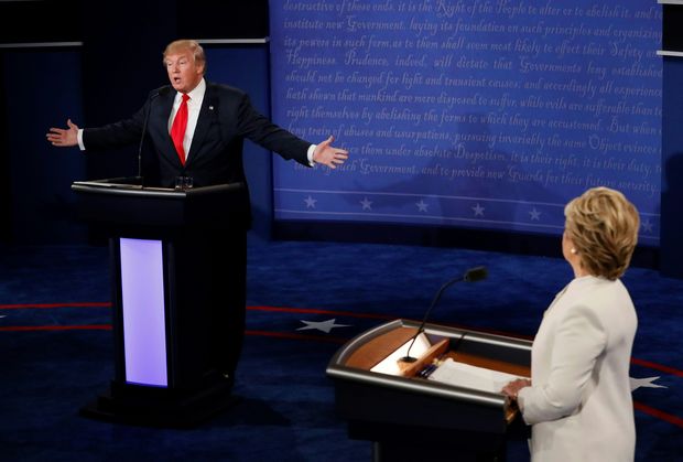Republican presidential nominee Donald Trump speaks as Democratic presidential nominee Hillary Clinton (R) looks on during the final presidential debate at the Thomas & Mack Center on the campus of the University of Las Vegas in Las Vegas, Nevada on October 19, 2016.