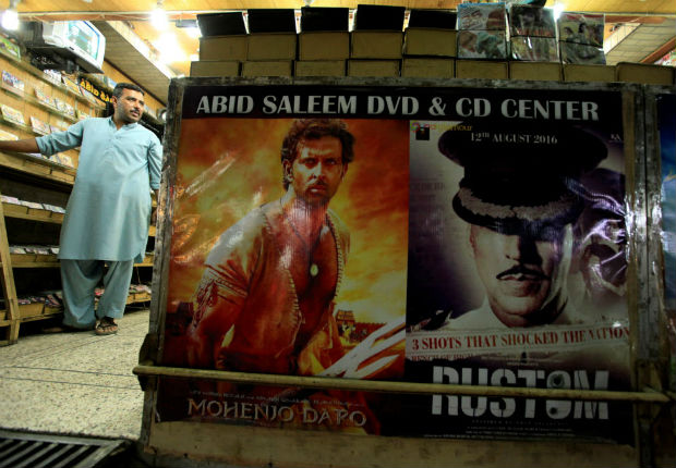 A man stands in a DVD shop displaying posters of Bollywood movies in Rawalpindi, Pakistan, October 20, 2016.