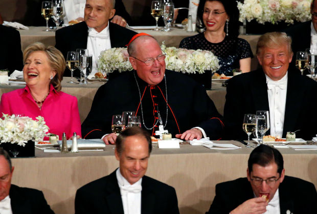 Democratic U.S. presidential nominee Hillary Clinton (L-R), Archbishop of New York Cardinal Timothy Dolan and Republican U.S. presidential nominee Donald Trump sit together at the Alfred E. Smith Memorial Foundation dinner in New York, U.S. October 20, 2016.
