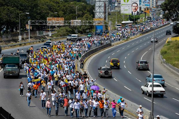 Opponents to President Nicolas Maduro's government march during a demonstration in Caracas on October 22, 2016. A group of women, led by Lilian Tintori, wife of imprisoned opposition Leopoldo Lopez, march in Caracas to protest the suspension of the recall referendum against President Nicolas Maduro as the opposition considered a breach of constitutional order. 