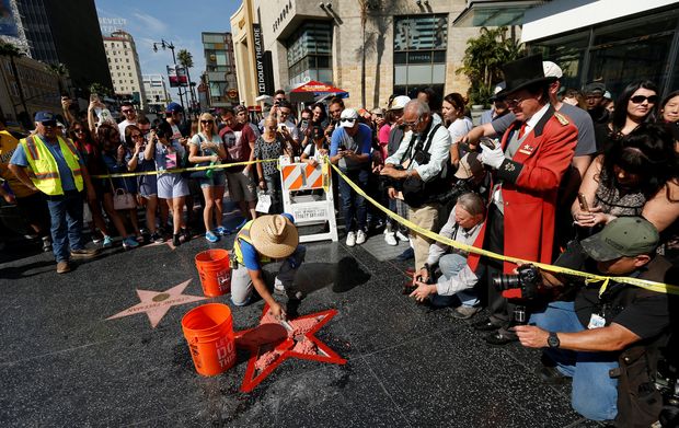 Cement is poured on Donald Trump's star on the Hollywood Walk of Fame after it was vandalized in Los Angeles, California U.S., October 26, 2016 .