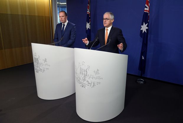 Australian Prime Minister Malcolm Turnbull (R) speaks as he stands with Immigration Minister Peter Dutton during a media conference in Sydney, Australia, October 30, 2016. AAP/Paul Miller/via REUTERS ATTENTION EDITORS - THIS IMAGE WAS PROVIDED BY A THIRD PARTY. EDITORIAL USE ONLY. NO RESALES. NO ARCHIVE. AUSTRALIA OUT. NEW ZEALAND OUT. ORG XMIT: DBG500