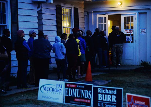 DURHAM, N.C - NOVEMBER 8: Early morning voters try to make their way inside a voting precinct to get out of the cold temperatures on November 8, 2016 in Durham, North Carolina. Precincts are expected to be crowded across the battleground state. Citizens of the United States will choose between Republican presidential candidate Donald Trump and Democratic presidential candidate Hillary Clinton as they pick their choice for the next president of the United States. 