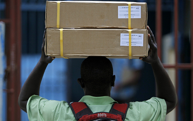 A man carries a box of electoral material into a polling station in Port-au-Prince, Haiti, Saturday, Nov. 19, 2016. Sunday's voters will choose a president, with the top two finishers going to a Jan. 29 runoff, as well as senators and members of the Chamber of Deputies. (AP Photo/Ricardo Arduengo) ORG XMIT: XRA103