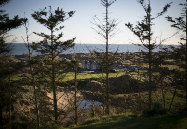 Trees and a fence, built by President-elect Donald Trump at his golf course, and blocking the views from David and Moira Milne's home, in Balmedie, Scotland, Nov. 18, 2016. Trump built the wall, blocking the sea view for several local residents who refused to sell their homes, and then he sent them the bill - part of a trail of unmet promises on one of his golf courses. (Jeremy Sutton-Hibbert/The New York Times)