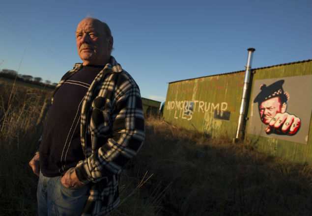 Michael Forbes, a quarry worker whose home sits on the opposite side of President-elect Donald Trump's golf course, in Balmedie, Scotland, Nov. 18, 2016. Forbes, whom Trump called a "disgrace" for refusing to sell his home, flies a "Hillary for President" flag near the property line - part of a trail of unmet promises on one of his golf courses, and lashed out at homeowners who stood in his way. (Jeremy Sutton-Hibbert/The New York Times)