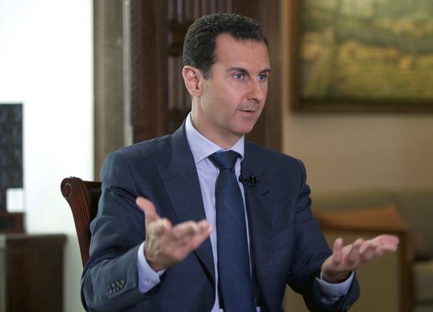 In this Wednesday, Sept. 21, 2016 photo released by the Syrian Presidency, Syrian President Bashar Assad speaks to The Associated Press at the presidential palace in Damascus, Syria. The House on Nov. 15, overwhelmingly approved bipartisan bills to crack down on supporters of Syrian President Bashar Assad's government and renew a decades-old Iran sanctions law. Swift passage underscored broad support on Capitol Hill for punishing financial backers of the Syrian government and maintaining economic pressure on Tehran.(Syrian Presidency via AP) ORG XMIT: WX108