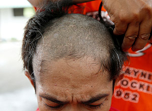 A newly-admitted drug user gets his head shaved at Central Luzon Drug Rehabilitation Center in Pampanga province, in northern Philippines, October 11, 2016. The soaring popularity of methamphetamine - a cheap and highly addictive drug D is overburdening health services and tearing families and communities apart in Southeast Asia, driving many countries to adopt hardline policies to fight the surge in narcotics use