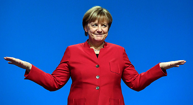 German Chancellor Angela Merkel gestures after addressing delegates during her conservative Christian Democratic Union (CDU) party's congress in Essen, western Germany, on December 6, 2016. German Chancellor Angela Merkel launches into campaign mode for elections taking place in 2017. / AFP PHOTO / TOBIAS SCHWARZ