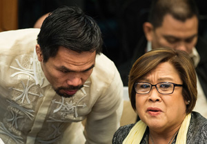 Philippine boxing icon and Senator Manny Pacquiao (L) talks to Senator Leila De Lima during the Senate drug hearing at the Senate building in Manila on November 23, 2016. Kerwin Espinosa, son of the late mayor Rolando Espinosa, was arrested in the United Arab Emirates last month and will face drug trafficking charges..