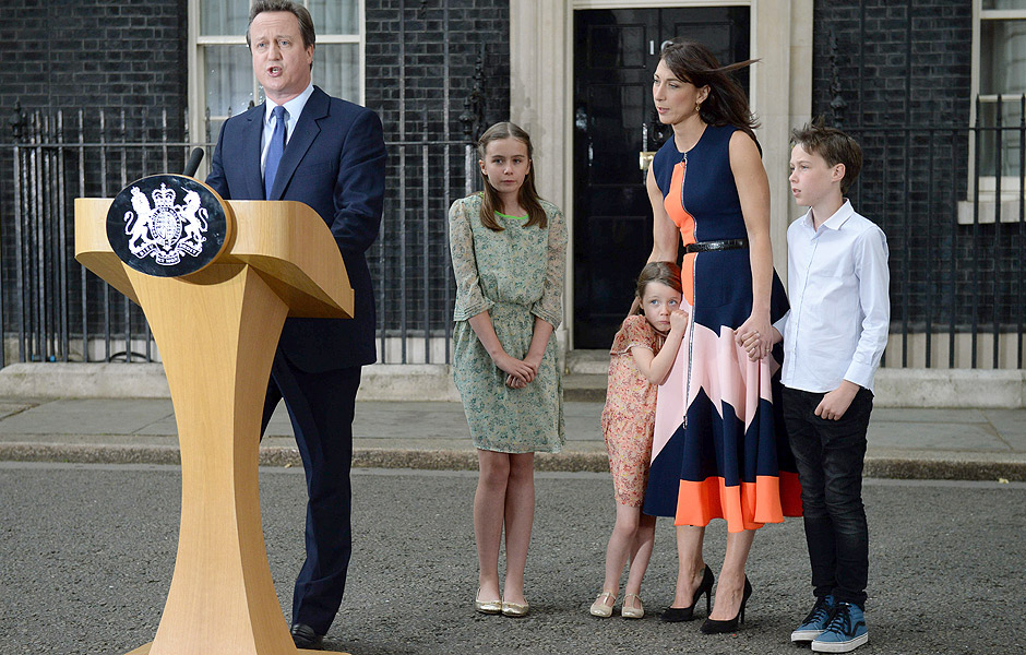 AFP PICTURES OF THE YEAR 2016 Outgoing British prime minister David Cameron speaks beside (L-R) his daughter Nancy Gwen, daughter Florence Rose Endellion, his wife Samantha Cameron and son Arthur Elwen outside 10 Downing Street in central London on July 13, 2016 before going to Buckingham Palace to tender his resignation to Queen Elizabeth II. Outgoing British prime minister David Cameron urged his successor Theresa May on Wednesday to maintain close ties with the EU even while negotiating to leave it, as he paid a fond farewell to MPs hours before leaving office. Cameron will tender his resignation on July 13 to Queen Elizabeth II at Buckingham Palace, after which the monarch will task the new leader of the Conservative Party Theresa May with forming a government. / AFP PHOTO / OLI SCARFF