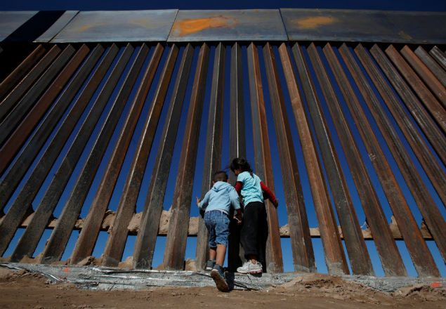 Children play at a newly built section of the U.S.-Mexico border wall at Sunland Park, U.S. opposite the Mexican border city of Ciudad Juarez, Mexico November 18, 2016. Picture taken from the Mexico side of the U.S.-Mexico border. Picture taken November 18, 2016. REUTERS/Jose Luis Gonzalez ORG XMIT: TBR04