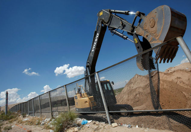 FILE PHOTO -- An excavator removes a fence, which will be replace by a section of the U.S.-Mexico border wall at Sunland Park, U.S. opposite the Mexican border city of Ciudad Juarez, Mexico, August 26, 2016. Picture taken from the Mexico side of the U.S.-Mexico border. REUTERS/Jose Luis Gonzalez/File Photo ORG XMIT: TOR135