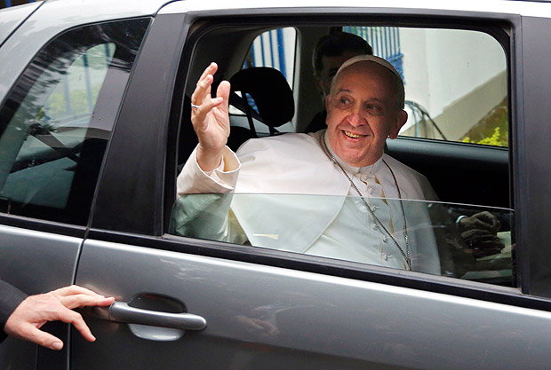 Pope Francis waves to journalists from a car as he exits "Quinta da Boa Vista" residence on his way to the Aparecida basilica for a mass, in Rio de Janeiro, Brazil, Wednesday July 24, 2013. Pope Francis returned to his home continent or the first time as pontiff, embarking on a seven-day visit meant to fan the fervor of the faithful around the globe. (AP Photo/Jorge Saenz) ORG XMIT: XJS105