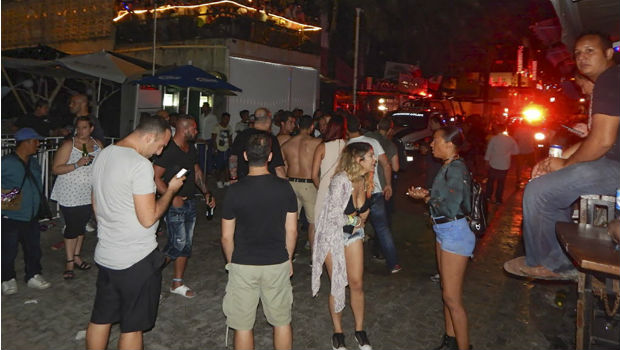 People remain in the street outside the Blue Parrot nightclub in Playa del Carmen, Quintana Ro state, Mexico where 5 people were killed, three of them foreigners, during a music festival on January 16, 2017. A shooting erupted at an electronic music festival in the Mexican resort of Playa del Carmen early Monday, leaving at least five people dead and sparking a stampede, the mayor said. Fifteen people were injured, some in the stampede, after at least one shooter opened fire before dawn at the Blue Parrot nightclub during the BPM festival. / AFP PHOTO / VICTOR VARGAS / MAXIMUM QUALITY AVAILABLE ORG XMIT: RSA1681