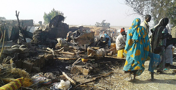 This handout image received courtesy of Doctors Without Border (MSF) on January 17, 2017, shows people standing next to destruction after an air force jet accidentally bombarded a camp for those displaced by Boko Haram Islamists, in Rann, northeast Nigeria. At least 52 aid workers and civilians were killed on January 17, 2017, when an air force jet accidentally bombed a camp in northeast Nigeria instead of Boko Haram militants, medical charity MSF said. / AFP PHOTO / Mdecins sans Frontires (MSF) / Handout / RESTRICTED TO EDITORIAL USE - MANDATORY CREDIT "AFP PHOTO / DOCTORS WITHOUT BORDERS (MSF)" - NO MARKETING NO ADVERTISING CAMPAIGNS - DISTRIBUTED AS A SERVICE TO CLIENTS ORG XMIT: NIGERIA03