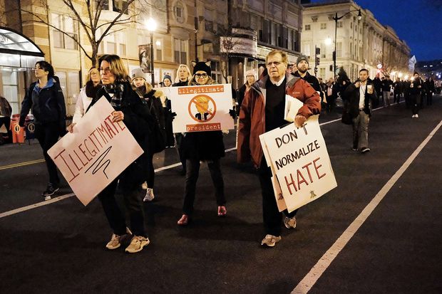 Protesters head to the National Mall on January 20, 2017 in Washington, DC. Washington and the entire nation are preparing for the transfer of the United States presidency later today as Donald Trump is sworn is as the 45th president Friday.