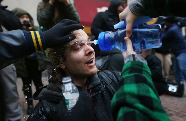 WASHINGTON, DC - JANUARY 20: A man is washed with water after being sprayed by police pepper spray during an anti-Trump demonstration on January 20, 2017 in Washington, DC. Protesters attempted to block an entrance to the inauguration ceremony. President-elect Donald Trump will be sworn in as the 45th U.S. President later today. Mario Tama/Getty Images/AFP == FOR NEWSPAPERS, INTERNET, TELCOS & TELEVISION USE ONLY ==