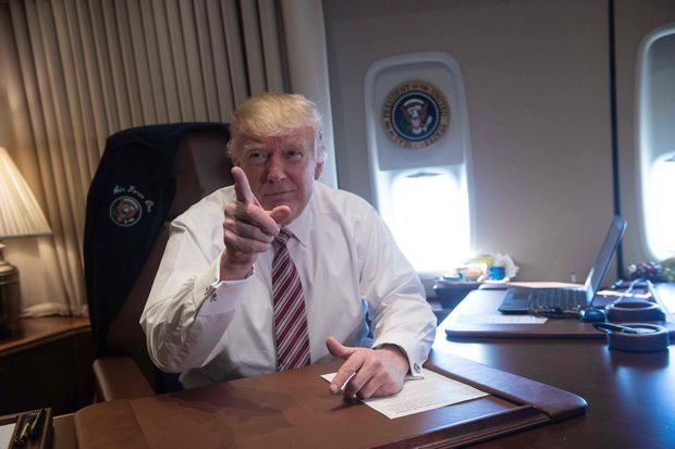 US President Donald Trump poses in his office aboard Air Force One at Andrews Air Force Base in Maryland after he returned from Philadelphia on January 26, 2017. Donald Trump made his maiden voyage outside the Washington area as US president Thursday, meeting with lawmakers to map out their 2017 policy strategy and smooth emerging differences between the White House and congressional Republicans.