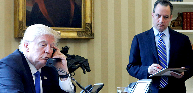 U.S. President Donald Trump, flanked by Chief of Staff Reince Priebus (R), speaks by phone with Russia's President Vladimir Putin in the Oval Office at the White House in Washington, U.S. January 28, 2017. REUTERS/Jonathan Ernst ORG XMIT: WAS915