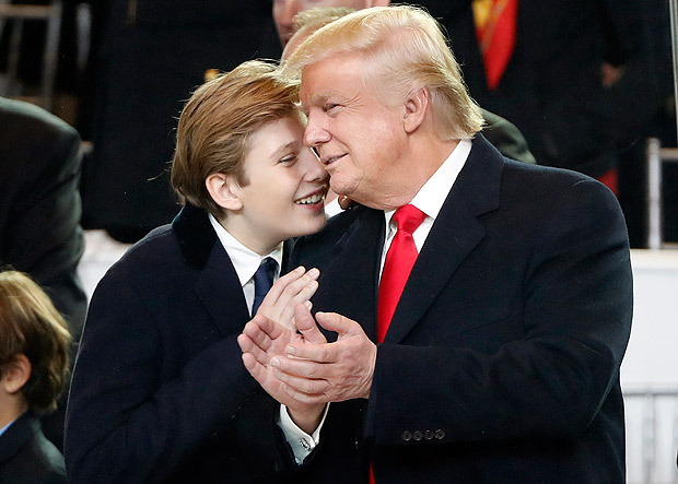 President Donald Trump, right, smiles with his son Barron as they view the 58th Presidential Inauguration parade for President Donald Trump in Washington. Friday, Jan. 20, 2017 (AP Photo/Pablo Martinez Monsivais) ORG XMIT: ILKS198