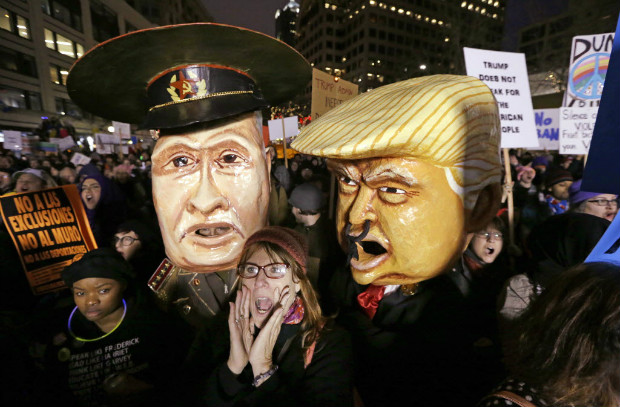 A woman shouts out as she stands in front of effigies portraying Russia's President Vladimir Putin and United States President Donald Trump at rally to oppose Trump's executive order banning travel to the United States by citizens of several countries Sunday, Jan. 29, 2017, in downtown Seattle. (AP Photo/Elaine Thompson) ORG XMIT: WAET107