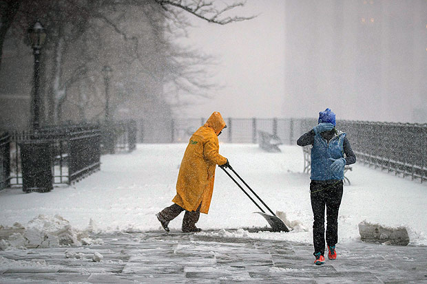 NEW YORK, NY - FEBRUARY 9: A man shovels snow on the Brooklyn Promenade on February 9, 2017 in the Brooklyn borough of New York City. Following a day of 60 degree temperatures, New York City is expected to receive significant snowfall throughout the day on Thursday. Drew Angerer/Getty Images/AFP == FOR NEWSPAPERS, INTERNET, TELCOS & TELEVISION USE ONLY =