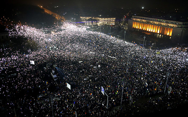 Tens of thousands of people gather for a demonstration in from of the government building in Bucharest, Romania, Sunday, Feb. 5, 2017. Romania's government met Sunday to repeal an emergency decree that decriminalizes official misconduct, a law that has prompted massive protests at home and widespread condemnation from abroad. (AP Photo/Darko Bandic) ORG XMIT: PJO116