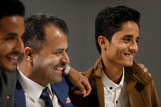 Os irmos iemenitas Tareq ( esq.) e Ammar Aziz se reencontram com o pai (centro) nos Estados Unidos