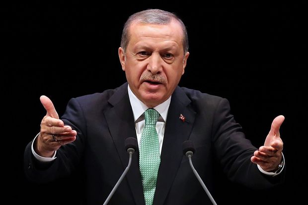 (FILES) This file photo taken on November 03, 2016 shows Turkish President Recep Tayyip Erdogan gesturing as he delivers a speech during the Living Human Treasures award ceremony at the Bestepe National Congress and Culture Centre in Ankara. Turkey's election board officially confirmed on February 11, 2017 that a referendum on constitutional changes that would expand President Recep Tayyip Erdogan's powers will take place on April 16. The government says the far-reaching changes are needed for more effective leadership, but opponents fear they will drag Turkey into one-man rule. Erdogan is seen by critics as increasingly autocratic after 14 years in power as both prime minister and president. / AFP PHOTO / ADEM ALTAN ORG XMIT: 1780