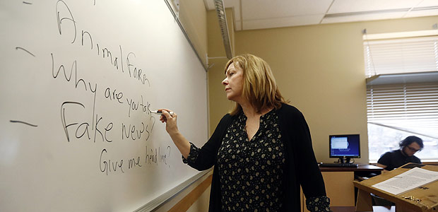 In this Friday, Jan. 20, 2017, photo, Pat Winters Lauro, a journalism professor at Kean University in Union, N.J., leads a class discussion talking about fake news. Teachers from elementary school through college have been ramping up media literacy training to recognize bogus reports and understand their potential to weaken civic culture. (AP Photo/Julio Cortez) ORG XMIT: NJJC201