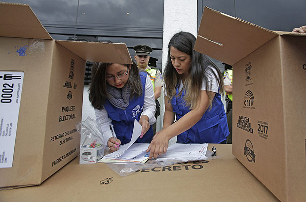 Election workers prepare electoral kits for the upcoming elections, in Quito, Ecuador, Friday, Feb. 17, 2017. Ecuadoreans will elect a new president, vice-president and National Assembly alongside a referendum on tax havens on Sunday. (AP Photo/Dolores Ochoa) ORG XMIT: DOR105