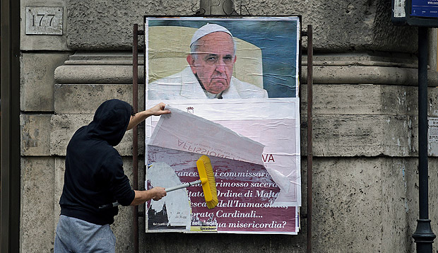 A worker covers with a banner reading "illegal poster" a poster depicting Pope Francis and accusing him of attacking conservative Catholics is seen in Rome, Italy, February 5, 2017. REUTERS/Max Rossi ORG XMIT: MXR03