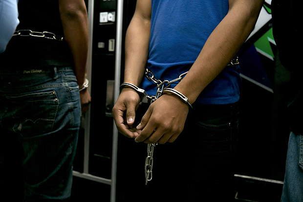 FILE  Men facing deportation are handcuffed at a Border Patrol station before taking a flight to Miami, en route to Honduras, in Brownsville, Texas, March 25, 2014. Many people assume that most of the people who entered the United States illegally are from Mexico. But many are not, and they arrived here in myriad ways. (Todd Heisler/The New York Times)